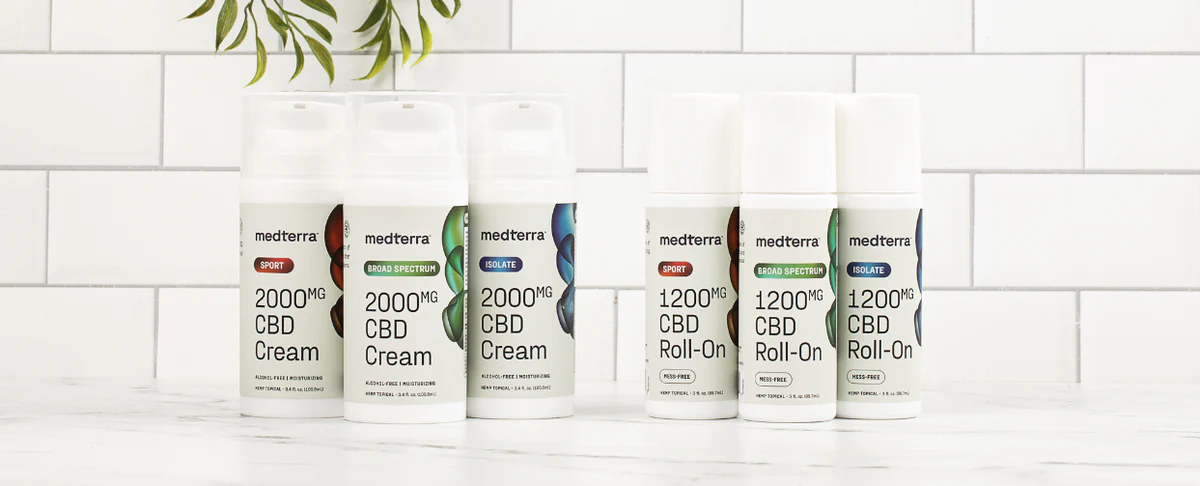 Medterra CBD products including 2000mg CBD Cream and 1200mg CBD Roll-On on a marble surface