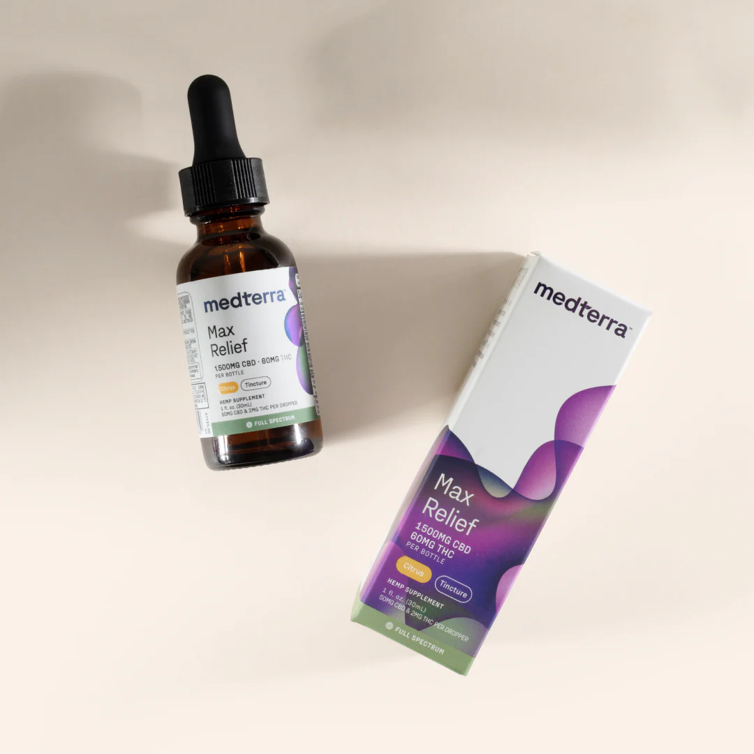 Angled view of Max Relief Full Spectrum CBD Oil bottle and box showing 1500 mg CBD and 60 mg THC on a beige background