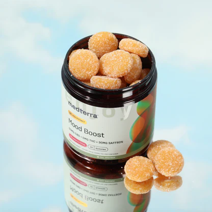 Top view of Medterra Mood Boost jar showing sugar coated orange gummies and label showing 50mg CBD, 5mg THC, 30mg saffron