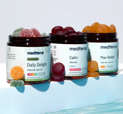Three jars of Medterra CBD gummies: Daily Delight (mixed fruit), Calm (dark red), Max Relief (orange) with gummies scattered around.