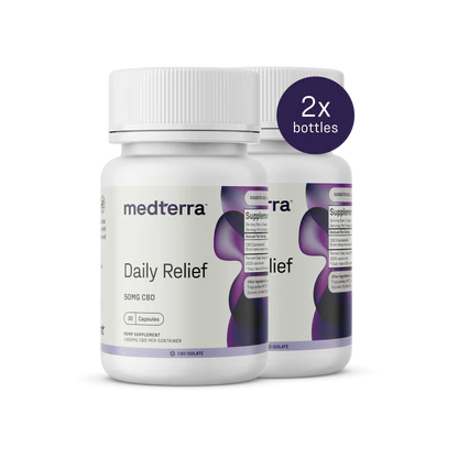 Two bottles of Medterra Daily Relief CBD Isolate Capsules, each containing 50mg of CBD. The bottles are white with a purple and black wavy design, featuring screw-top lids. A circular label indicates "2x bottles." The text on the bottles reads "Dietary Supplement" and includes organic MCT Coconut Oil.